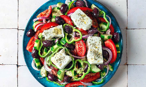 A vibrant, fresh Greek Salad Plate Classic with crumbled feta cheese